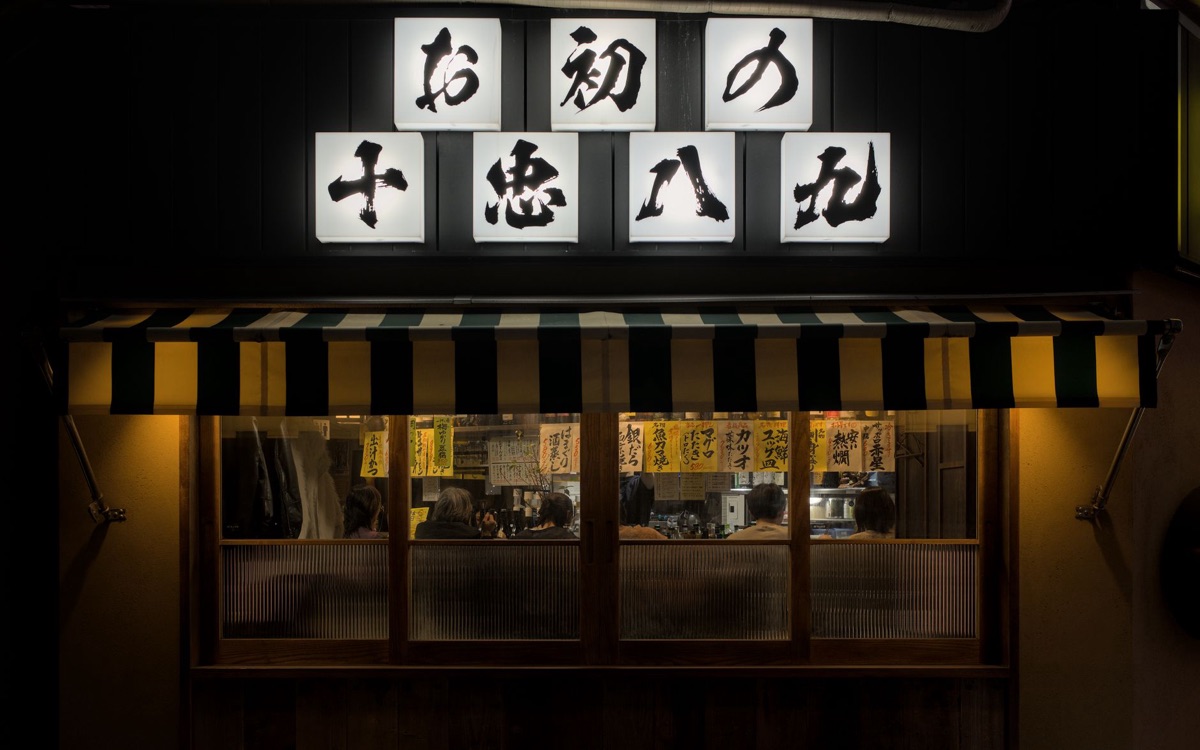 Osaka kushikatsu restaurant interior with wooden tables and shelves filled with kushikatsu sticks