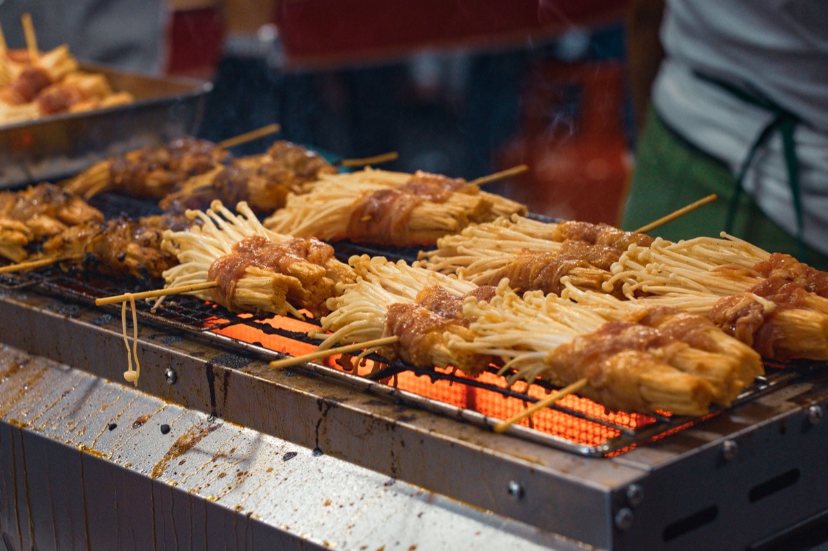 Dotonbori food stall with grilled skewers
