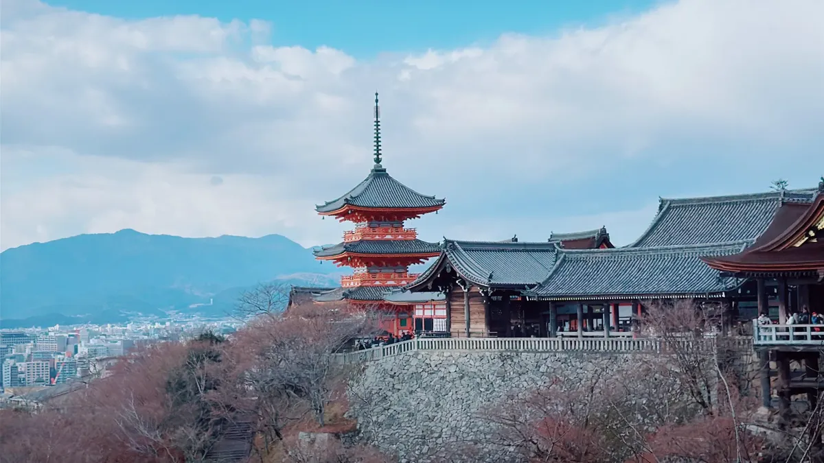 Discover the stunning architecture of Kiyomizu-dera Temple in Kyoto with breathtaking mountain views.